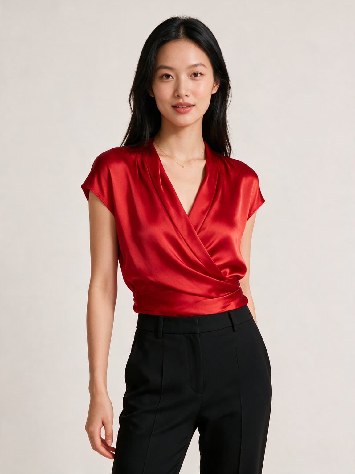 A woman in a scarlet satin wrap top, picked by her Steeze stylist